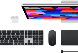 Top view of Mac accessories: Studio Display, AirPods, Magic Keyboard, Magic Mouse, and Magic Trackpad