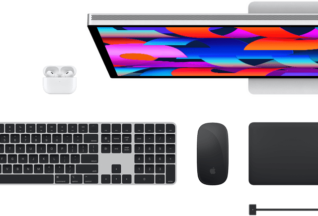 Top view of select Mac accessories: Studio Display, Magic Keyboard, Magic Mouse, Magic Trackpad, AirPods, and MagSafe charging cable