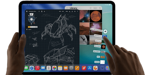 iPad Pro, space black color, left hand holding device, right hand pointing gesturing to manipulate multiple open app windows, a drawing app with sketches of mechanical designs, photos library of planets and space images, downloads folder files fanned out